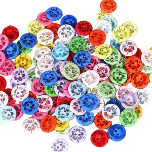 May include: A large assortment of colorful plastic buttons with a flower design. The buttons are in various shades of red, orange, yellow, green, blue, purple, pink, and white.