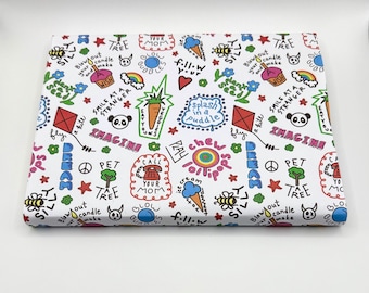 May include: White wrapping paper with a colorful repeating pattern of hand-drawn illustrations and text. The illustrations include a panda, a rainbow, a lollipop, a bee, a star, a peace sign, a phone, a candle, a tree, a flower, a kite, and a puddle. The text includes the words "smile at a stranger", "imagine", "pet a tree", "call your mom", "blow out your candle", "chew lollipops", "splash in a puddle", "fly a kite", "eat your veggies", "fill your cup", "silly", "ray", "peace", and "wish".
