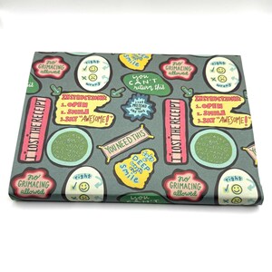 May include: A green wrapping paper with a repeating pattern of colorful illustrations and text. The text includes "I lost the receipt", "You need this", "Take a deep breath", "Smile", "No grimacing allowed", "Instructions: 1. Open 2. Smile 3. Say "Awesome!"