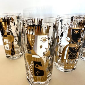 May include: Set of six clear glass highball glasses with gold and black playing card designs. Each glass features a different playing card king with a crown and a suit symbol.