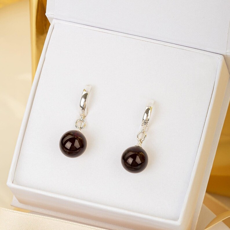 MONDRI jewelry gift packaging with cherry amber earrings inside
