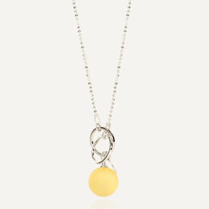 Close up of large lemon yellow amber pendant with 925 sterling silver bead chain