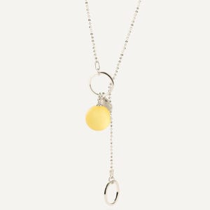 close view of large yellow matte amber pendant 14 mm and sterling silver details