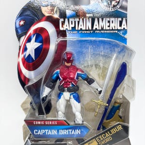 Pu&ograve; includere: Action figure di Captain Britain della serie Marvel Comics, confezionata su una carta blu e bianca. La figura indossa un costume rosso, bianco e blu e tiene in mano una spada d'argento. La confezione presenta Captain America e il testo "Captain America: The First Avenger".