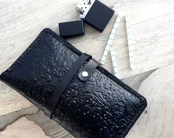 Black leather tobacco pouch with a skull print and inner pockets