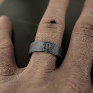May include: A black ring with the number "10" printed on it.