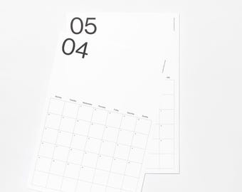 May include: Two stacked white paper calendar sheets with black text. The top sheet displays the numbers 05 and 04 in a large sans-serif font, followed by a grid layout with days of the week labeled Monday through Sunday in English.