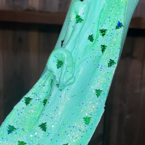 May include: Teal slime with green glitter shaped like Christmas trees.