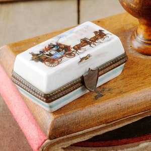 Vintage porcelain snuff box, porcelain pillbox with stagecoach in a snowy setting and floral decoration