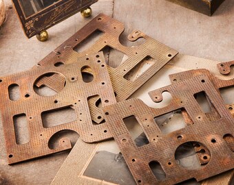 May include: Four antique brass metal plates with intricate cut-out designs. The plates are stacked on top of each other and have a rustic, aged appearance.