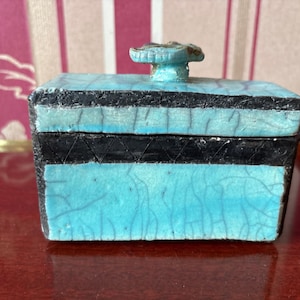 May include: A white ceramic mug with a colorful floral design. The mug features a handle and a glossy finish. The flowers are in shades of pink, purple, and yellow. The mug is likely for beverages.