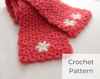 Puede incluir: Una bufanda de crochet rosa con flores de crochet blancas. Patrón de crochet.