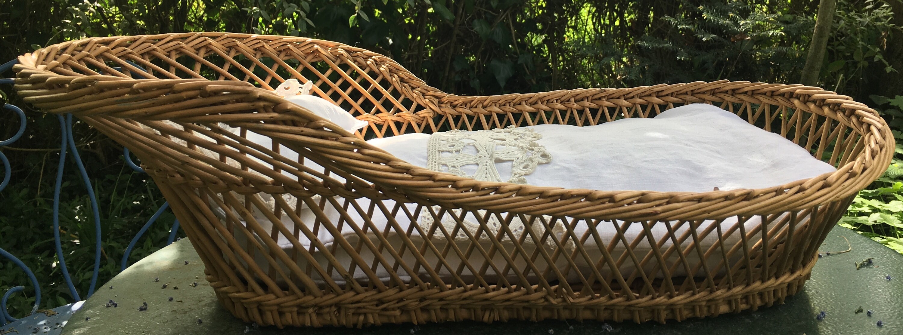 Rattan toy baby crib with French vintage linen