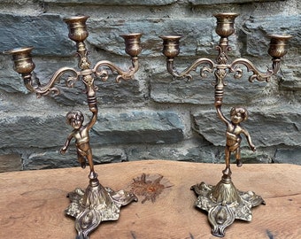 Pair of brass cherub candlestick holders