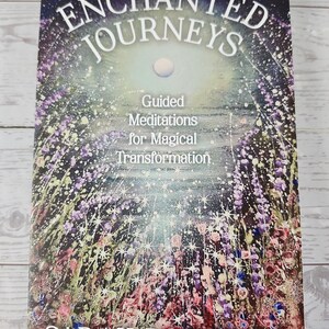 May include: A book titled Enchanted Journeys: Guided Meditations for Magical Transformation by Sarah Robinson. The cover features a dark, starry night sky above a vibrant, colorful field of flowers with sparkling white star-like accents.
