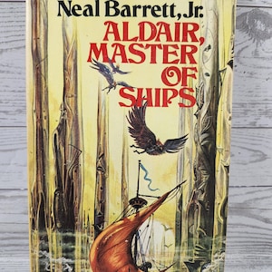May include: A paperback book titled Aldair, Master of Ships by Neal Barrett, Jr. The cover features a yellow background with tall, textured, tree-like structures, a large orange sail on a ship, and dark birds flying in the sky above the vessel.
