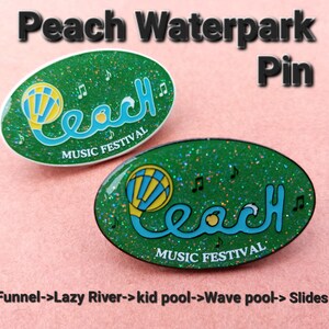 Puede incluir: Dos pines de esmalte verde y blanco con purpurina. Ambos pines presentan un globo aerostático azul y amarillo con la palabra "Peach" en una fuente azul cursiva. El texto "Music Festival" está impreso debajo de la palabra "Peach".