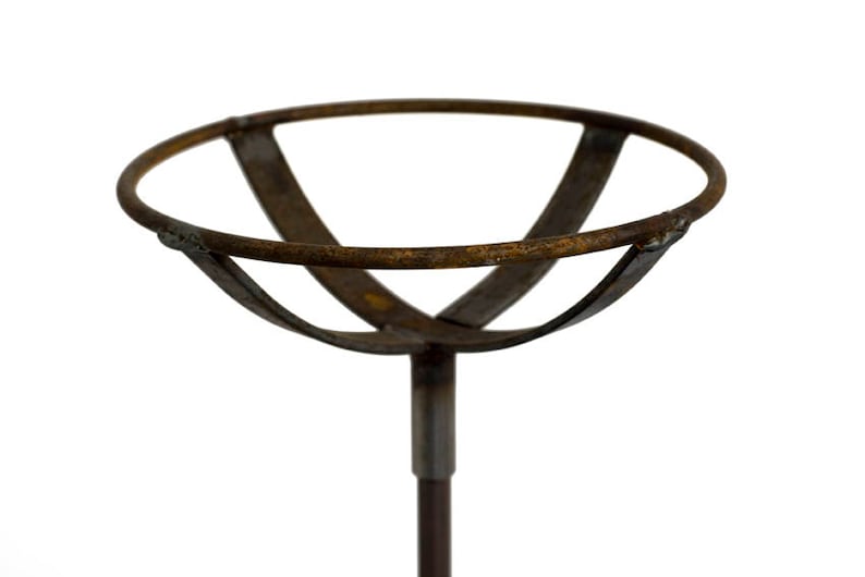 May include: A rustic metal plant stand with a circular top and a single stem. The stand is made of brown metal with a weathered finish.