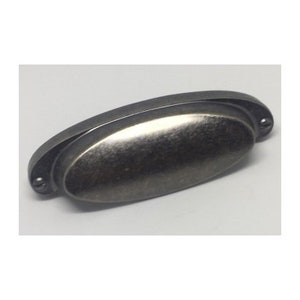 May include: A silver-toned oval cabinet pull with a brushed finish.