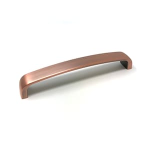 May include: A brushed copper cabinet pull with a rounded rectangular shape.