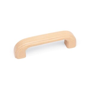 May include: A light wood cabinet pull with a rounded rectangular shape.
