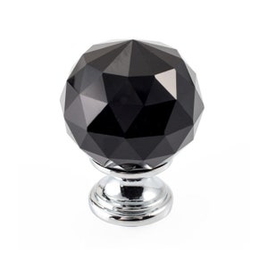 May include: Black crystal cabinet knob with a faceted design and a chrome base.