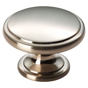 May include: A brushed nickel cabinet knob with a round top and a base. The knob has a smooth, polished finish.