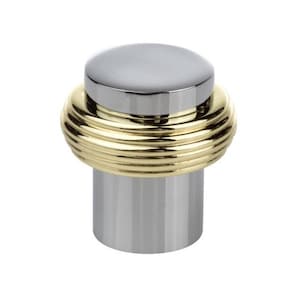 May include: A chrome and gold door stop. The top is a flat, circular chrome piece. The middle section is a gold-coloured, ridged band. The base is a cylindrical chrome shape. This decorative door stop adds a touch of elegance to any room.