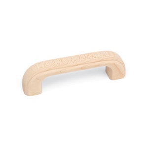 May include: A light wood cabinet pull with a rounded rectangular shape.