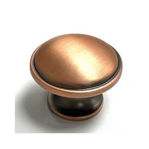May include: A copper cabinet knob with a brushed finish and a raised edge. The knob has a round top and a cylindrical base.