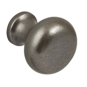 May include: A round, pewter-coloured cabinet knob with a slightly raised, smooth surface.