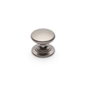May include: A silver-coloured cabinet knob with a rounded top and a circular base. The knob has a simple, classic design and is likely made of metal. Suitable for drawers and cabinets.