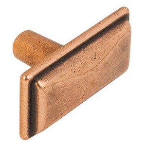 May include: A copper-toned cabinet knob with a rectangular base and a round, protruding handle. The knob has a slightly distressed finish.