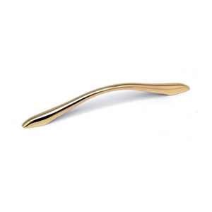 May include: A gold-toned cabinet pull with a curved design.