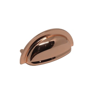 May include: A copper cabinet knob with a rounded, slightly domed shape. The knob has a smooth, polished finish.