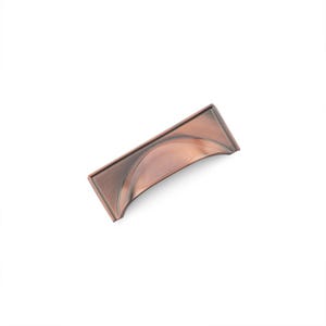 May include: A copper-toned cabinet pull with a curved, rectangular shape. The pull has a smooth, slightly textured surface.