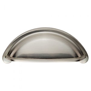 May include: A brushed nickel cabinet pull with a curved, half-round shape.
