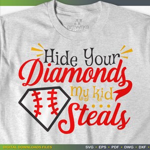 May include: A gray t-shirt with the text "Hide Your Diamonds My Kid Steals" in red and black lettering. A baseball diamond graphic is in the center of the shirt.