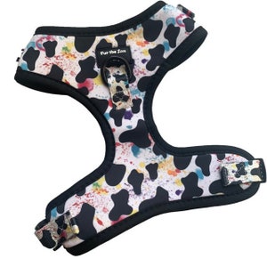 May include: A black and white dog harness with a colorful splatter paint design. The harness has a black adjustable strap and a metal buckle. The text "Fur the Love" is printed on the strap.
