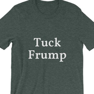 May include: A dark green t-shirt with the text "Tuck Frump" printed in white.