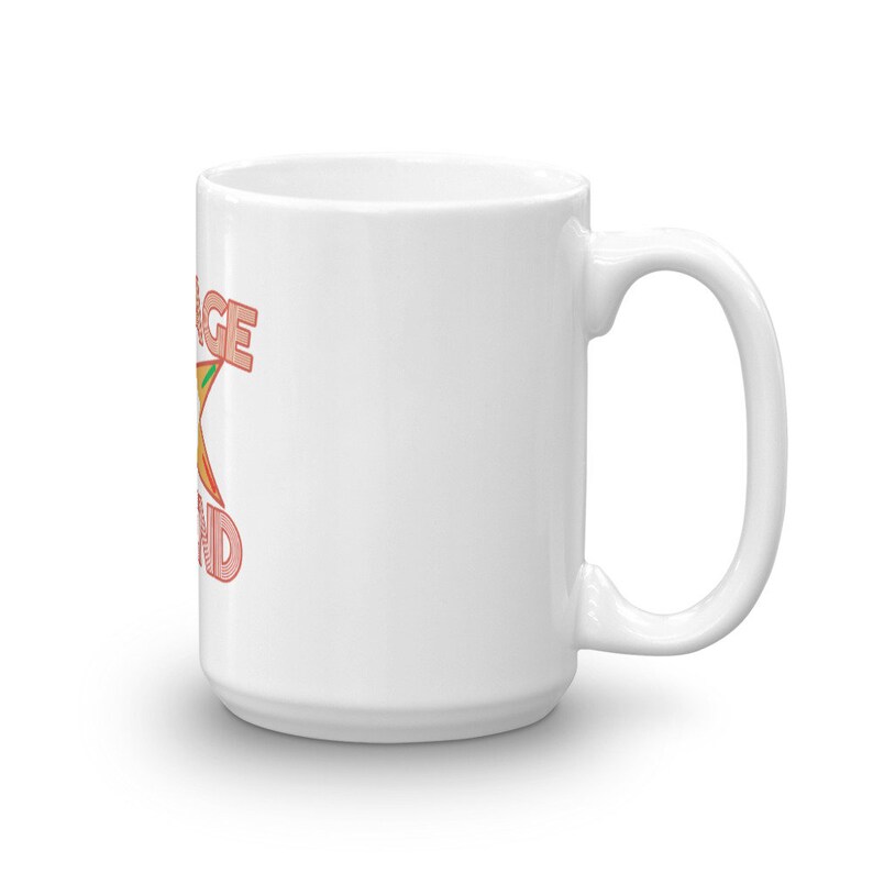 Pode incluir: Caneca de cer&acirc;mica branca com uma estrela rosa e laranja e o texto "Orange you glad" impresso no lado.