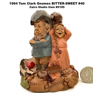 May include: A detailed figurine of two gnomes, one with a stern expression and the other smiling. The base features the words "Bitter" and "Sweet", along with a quarter for size comparison. The figurine is from the 1994 Tom Clark Gnomes collection.