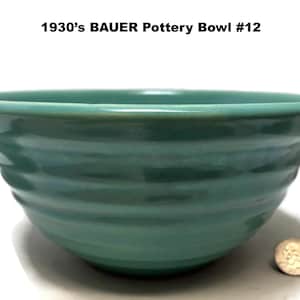 May include: A vintage teal-colored Bauer pottery bowl, circa 1930s, with a ribbed exterior. The bowl is round with a wide rim and is displayed on a white surface. The text "1930's BAUER Pottery Bowl #12" is visible.