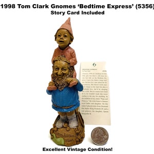 May include: A vintage Tom Clark Gnomes figurine titled 'Bedtime Express' (5356). The figurine depicts a gnome carrying a child on its shoulders. The base has the words 'Bedtime Express' and a green leaf. A story card is included.
