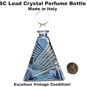 May include: A vintage, blue lead crystal perfume bottle with a geometric design. The bottle is triangular with a round stopper. The text "SC Lead Crystal Perfume Bottle Made in Italy" is visible. The text "Excellent Vintage Condition!" is also visible.