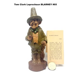 May include: A set of three ceramic mugs with a speckled, matte finish. The mugs are in shades of cream, light gray, and dark gray. Each mug has a simple, minimalist design and a rounded handle.