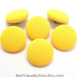 May include: Six yellow fabric covered buttons with a shiny silver shank.