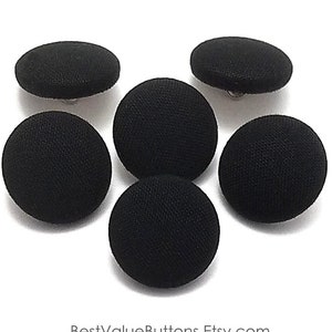 May include: Six black fabric covered buttons with silver shanks.