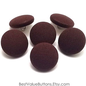 May include: Six brown fabric covered buttons with a shank attachment.