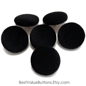 May include: Six black velvet buttons, each measuring approximately 1 inch in diameter.
